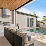 Patio and outdoor living area with pool by by Blue Daze Designs, orlando interior design