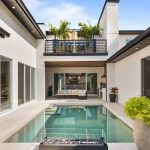 Balcony and courtyard with pool by Blue Daze Designs, orlando interior design