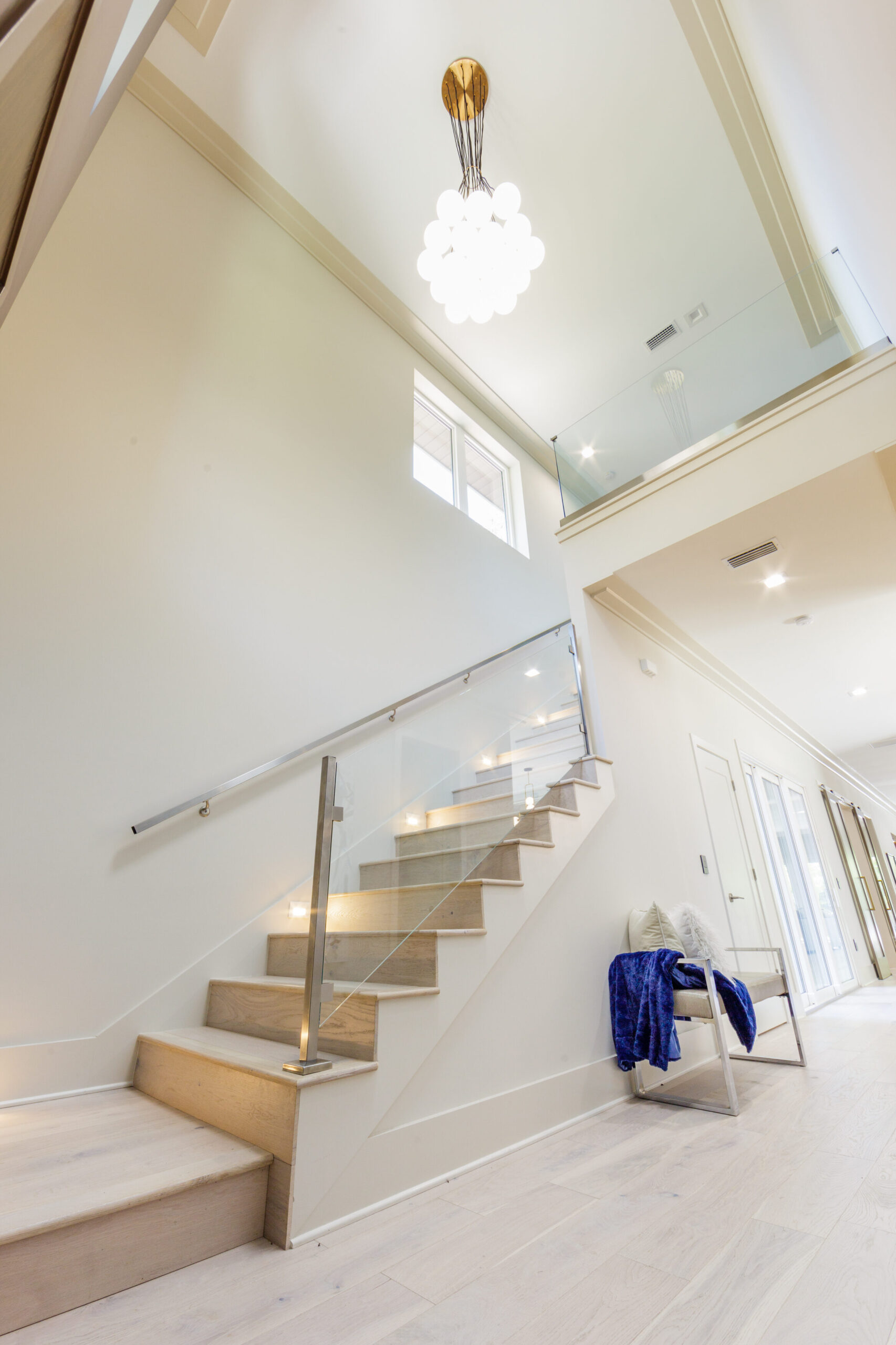 Foyer Clean elegant foyer staircase. Full-service interior design Orlando. Photo by Steven Miller